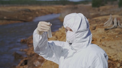 The Scientist in a Chemical Protective Suit Examines the Samples in the Contaminated Area. Biohazard