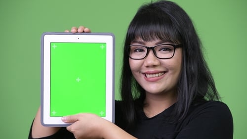 Smiling Woman Holding Tablet with Green Screen