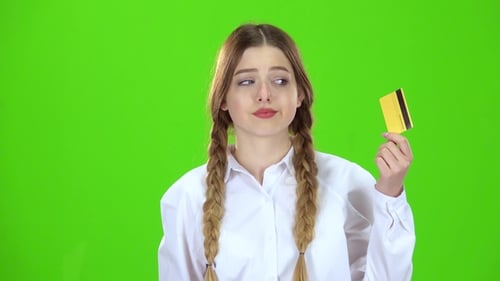 Schoolgirl in White Blouse with a Credit Card Is Sad Green Screen