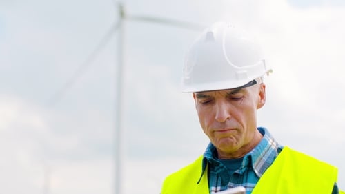 Engineer Using Digital Tablet When Doing Wind Turbine Inspection