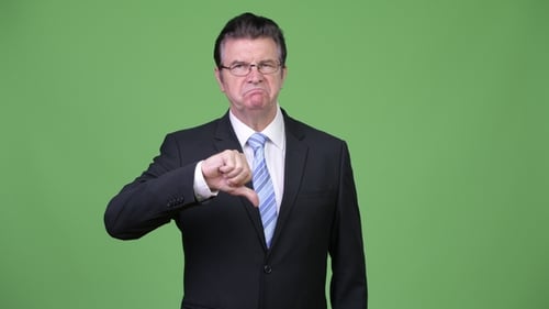 Frustrated Senior Handsome Businessman Giving Thumbs Down