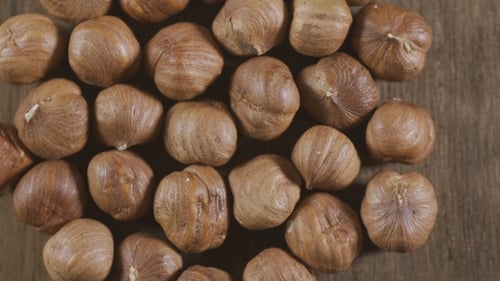 Pile of Shelled Hazelnuts on Wood Surface