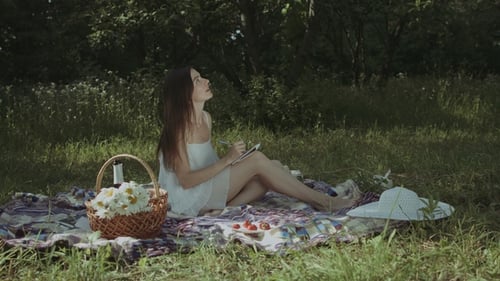 Woman Drawing in Meadow on Sunny Day