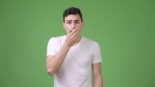 Surprised Young Adult Covering Mouth on Green Screen