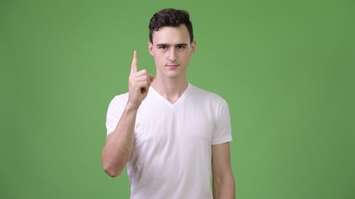 Young Man Raises Index Finger on Green Screen