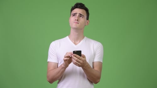 Young Adult Using Phone on Green Screen