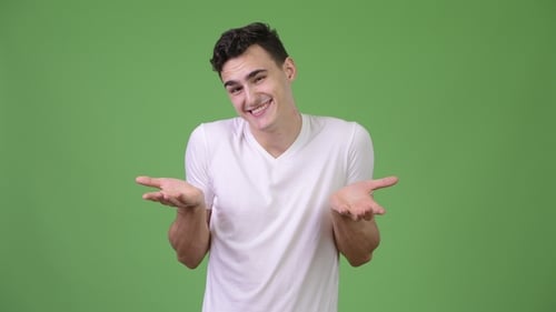Young Handsome Man Shrugging Shoulders
