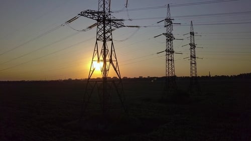 Power Lines at Sunset in Rural Field