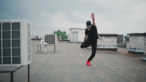 Young Man Breakdancing on a Rooftop