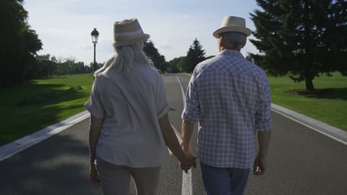 Stylish Senior Couple Walking Holding Hands