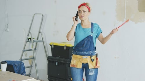 Doing Home Repairs Woman Talking on Smartphone