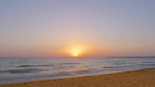 Beautiful Morning Sunrise in Sea and Soft Water Waves on Sandy Beach