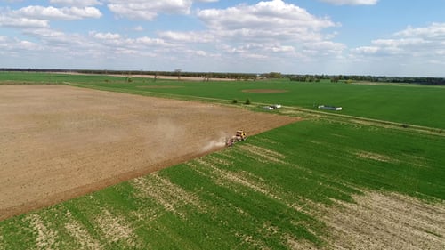 Aerial Footage of a Tractor on a Field