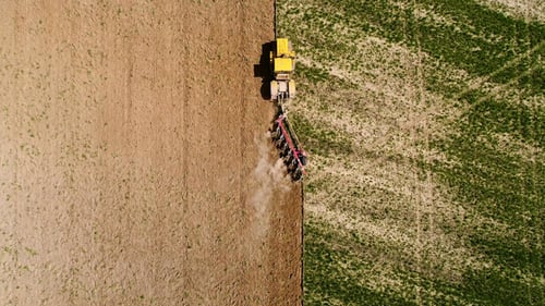 Aerial Footage of a Tractor on a Field