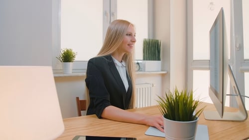 Happy Female Working on Computer in Office