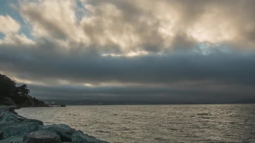 Moody Ocean View at Sunset with Dramatic Clouds