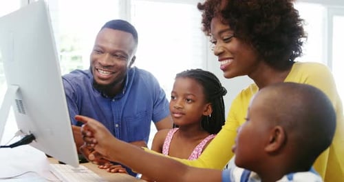 Happy family using desktop computer