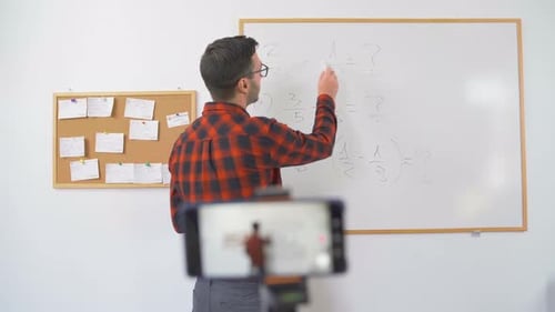 Teacher Explains Math Lesson on Whiteboard for Online Class