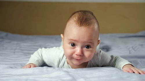 Cute Baby Lying on Stomach on Bed