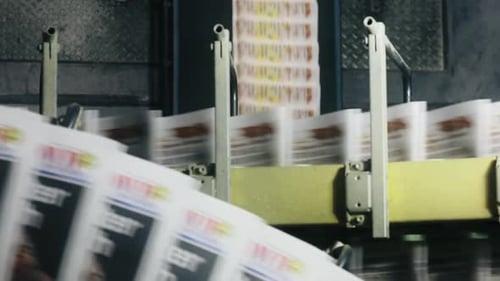 Newspapers on a Conveyor Belt in a Factory