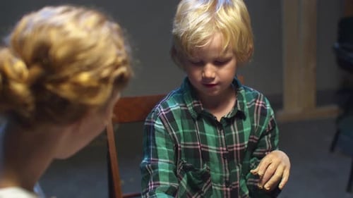 Child and Adult Doing Art Project Indoors