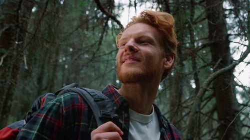 Man Standing in Green Forest