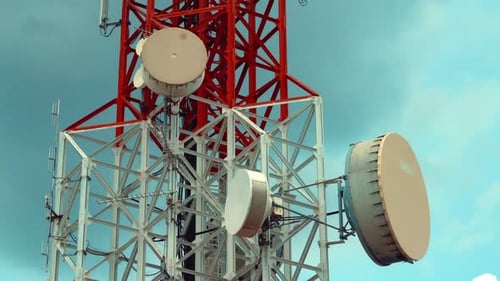 Large Telecommunication Tower Against Sky and Clouds in Background
