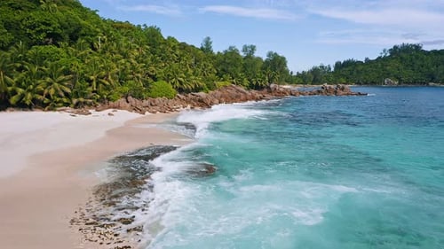 Aerial Drone Lot Altitude Fly Above Tropical Sandy Beach with Ocean Waves at Mahe Island Seychelles