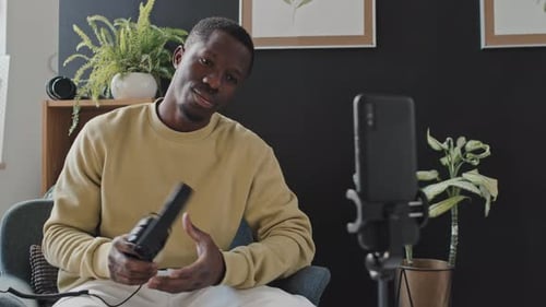 Young Man Recording a Podcast with Headphones