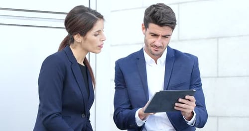 Business Professionals Using Tablet Outside Office