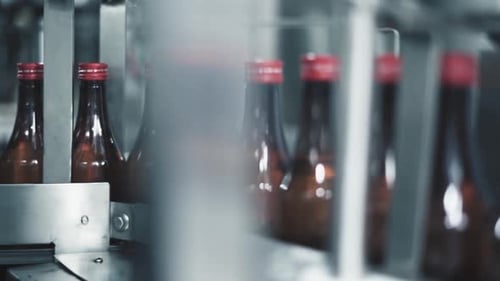 Conveyor belt with bottles filled with medicine drug has stopped, machinery need repairing as soon a