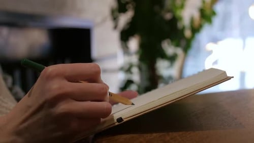 Hands of Young Artist Girl Makes a Sketch in Cafe