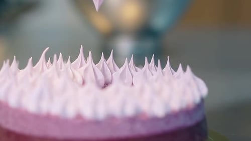 Confectioner Gradually Fills Cake Top Center with Cream
