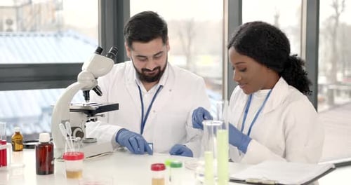 Two Scientists Working Together in Modern Laboratory
