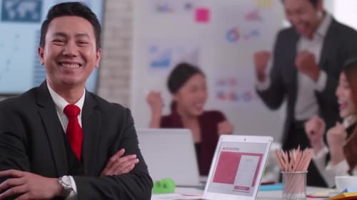 Enthusiastic Man Presents with Celebrating Team