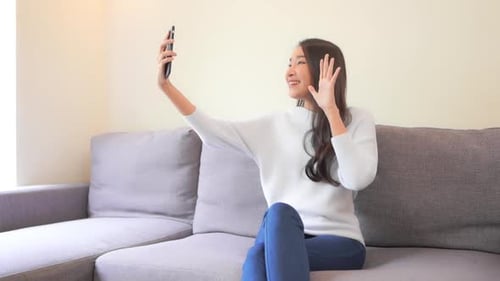 Woman Video Chatting on Cell Phone at Home
