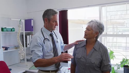 Doctor Discussing Health with Patient in Clinic