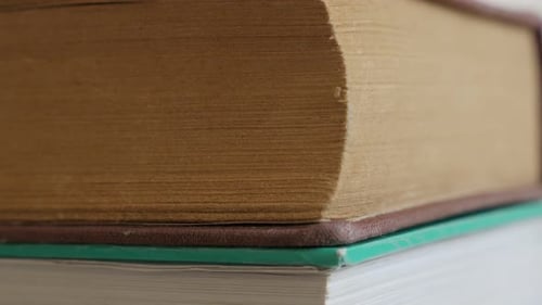 Shallow DOF old books darkened with shelf dust 4K 2160p 30fps UltraHD footage - Close-up of vinta