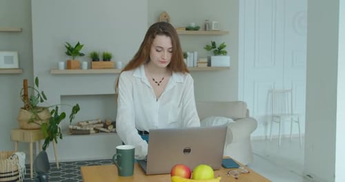 Young Woman Working on Laptop at Home