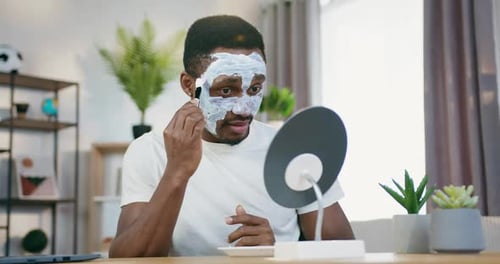 Man Applying a Face Mask in Home Bathroom