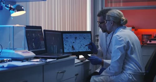 Scientists Watching Monitor and Analyzing