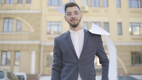 Attractive and Confident Young Businessman in an Official Suit Threw Out Business Papers