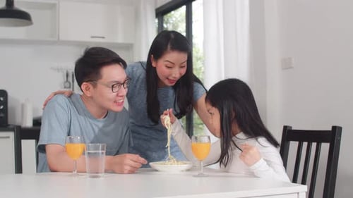 Happy Family Enjoying Meal Together in Bright Kitchen