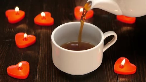 Coffee Pour with Heart Candles on Dark Wood