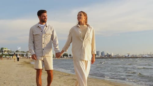 Happy Couple Walking Along Summer Beach