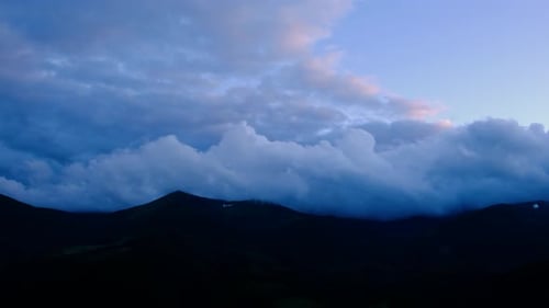 Mountain Range with Dramatic Clouds at Sunrise