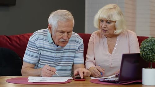 Senior Old Couple Stressed About Paperwork Discuss Unpaid Bank Debt Holding Bills Check Expenses
