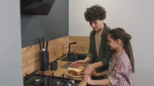 Mother and Child Making Sandwiches Together in Kitchen