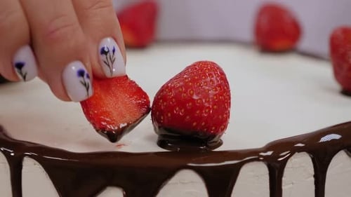 Strawberry Cake Being Decorated With Slice of Strawberry