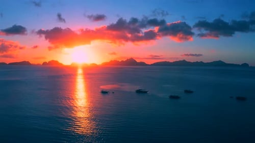 Sailboat in the Sea in the Evening Sunlight Over Beautiful Big Mountains Background